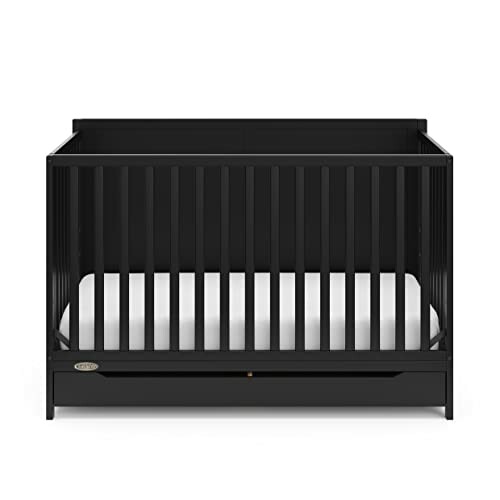 Black wooden baby crib with slatted sides.