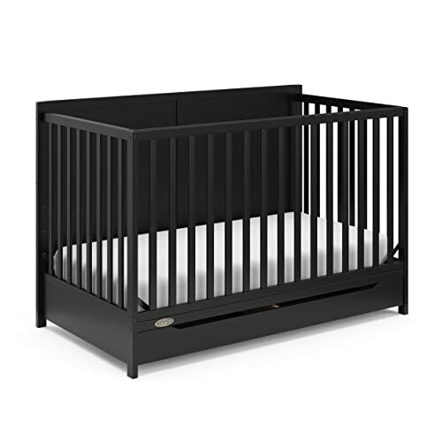 Black baby crib with white mattress.